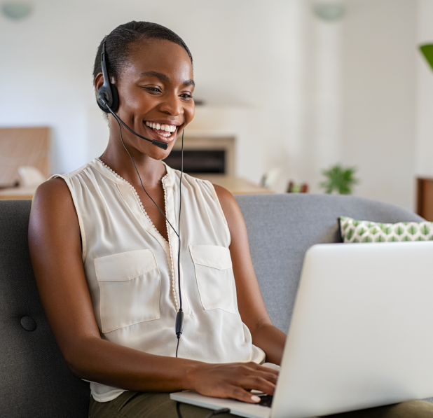 Smiling woman in a suit using the call forwarding feature on a laptop